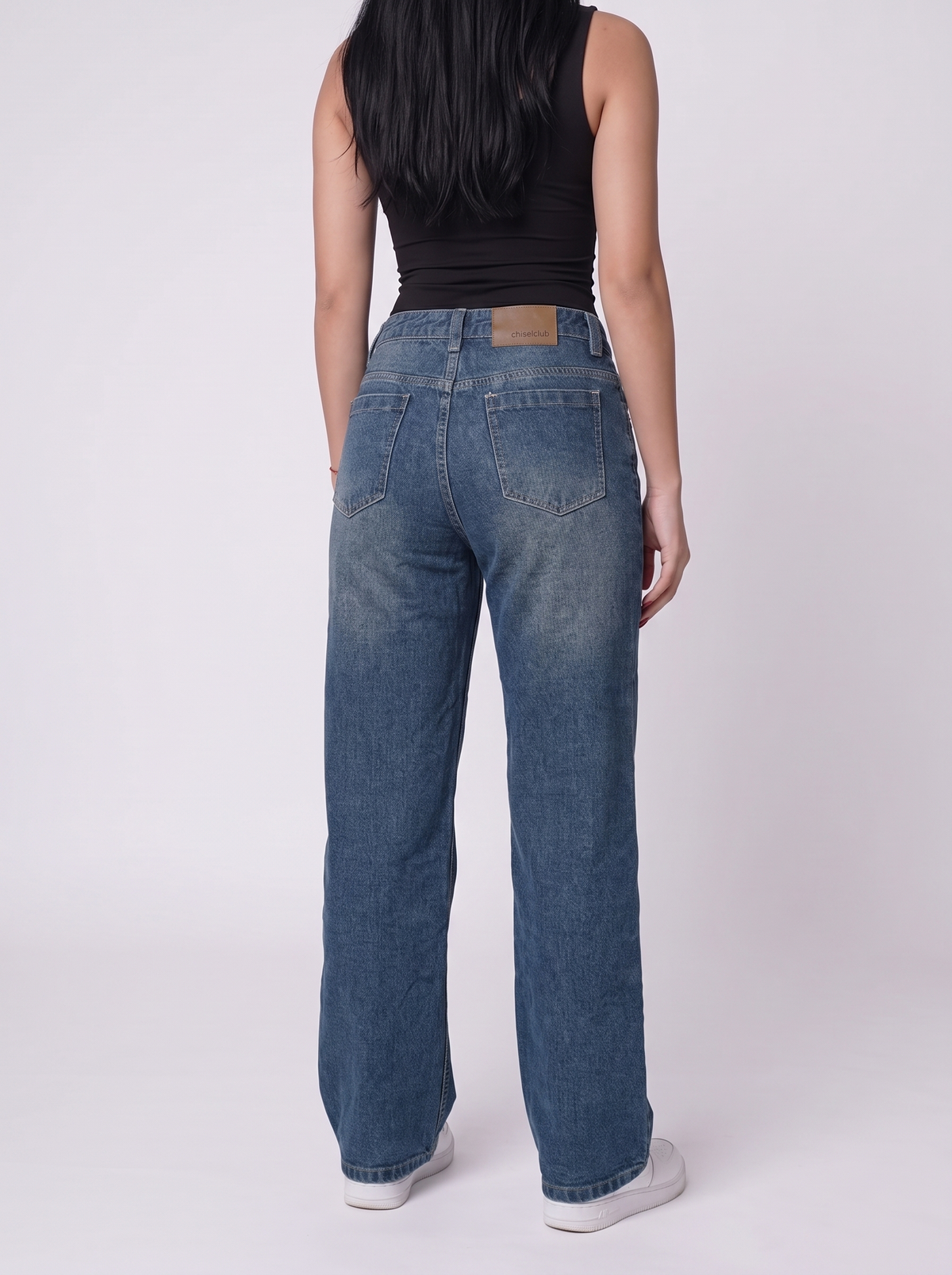 The Relaxed Wide — back view, waist to feet, vintage indigo wash