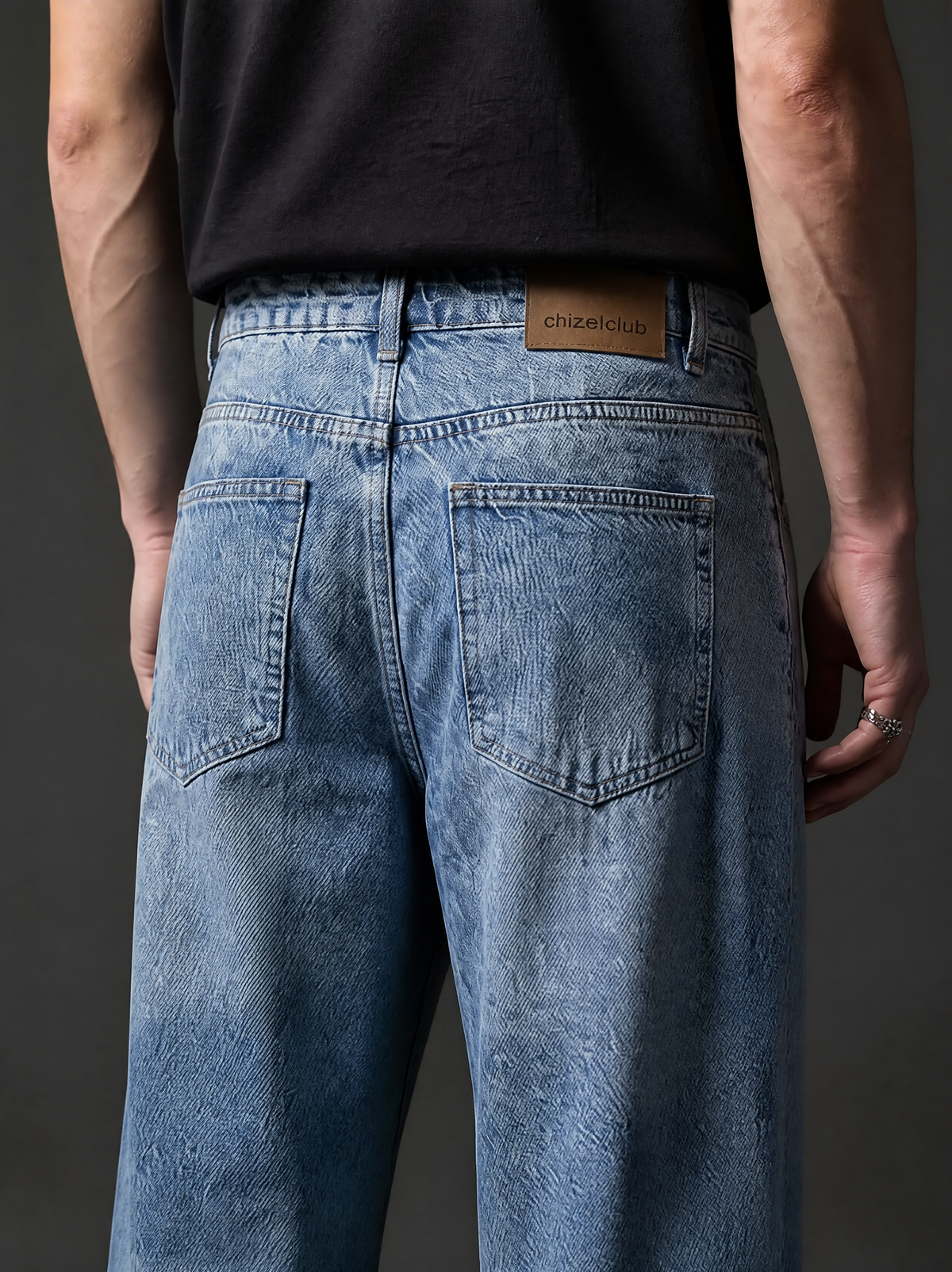 The Light Wash Wide — back close-up showing chizelclub leather patch